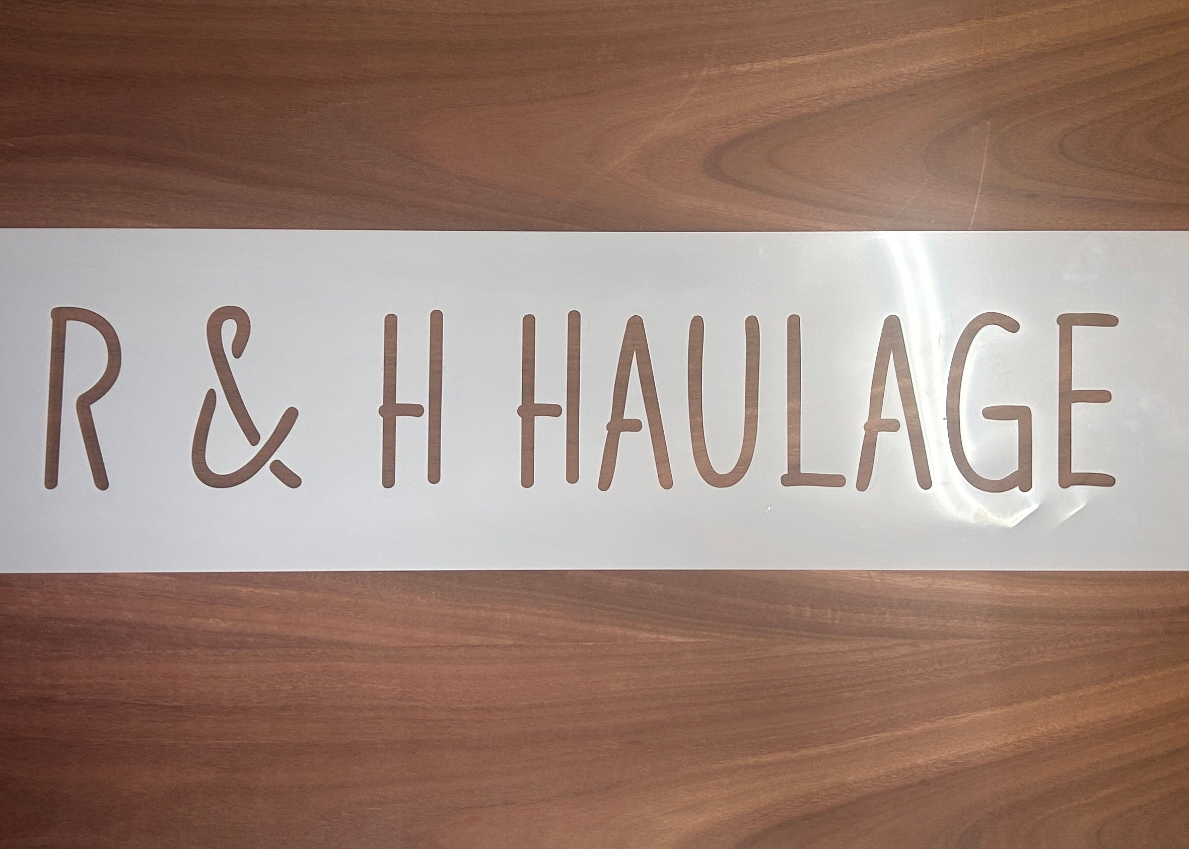 Custom laser-cut truck stencil for R & H Haulage, suitable for branding transport vehicles, shipping containers, or warehouse equipment.