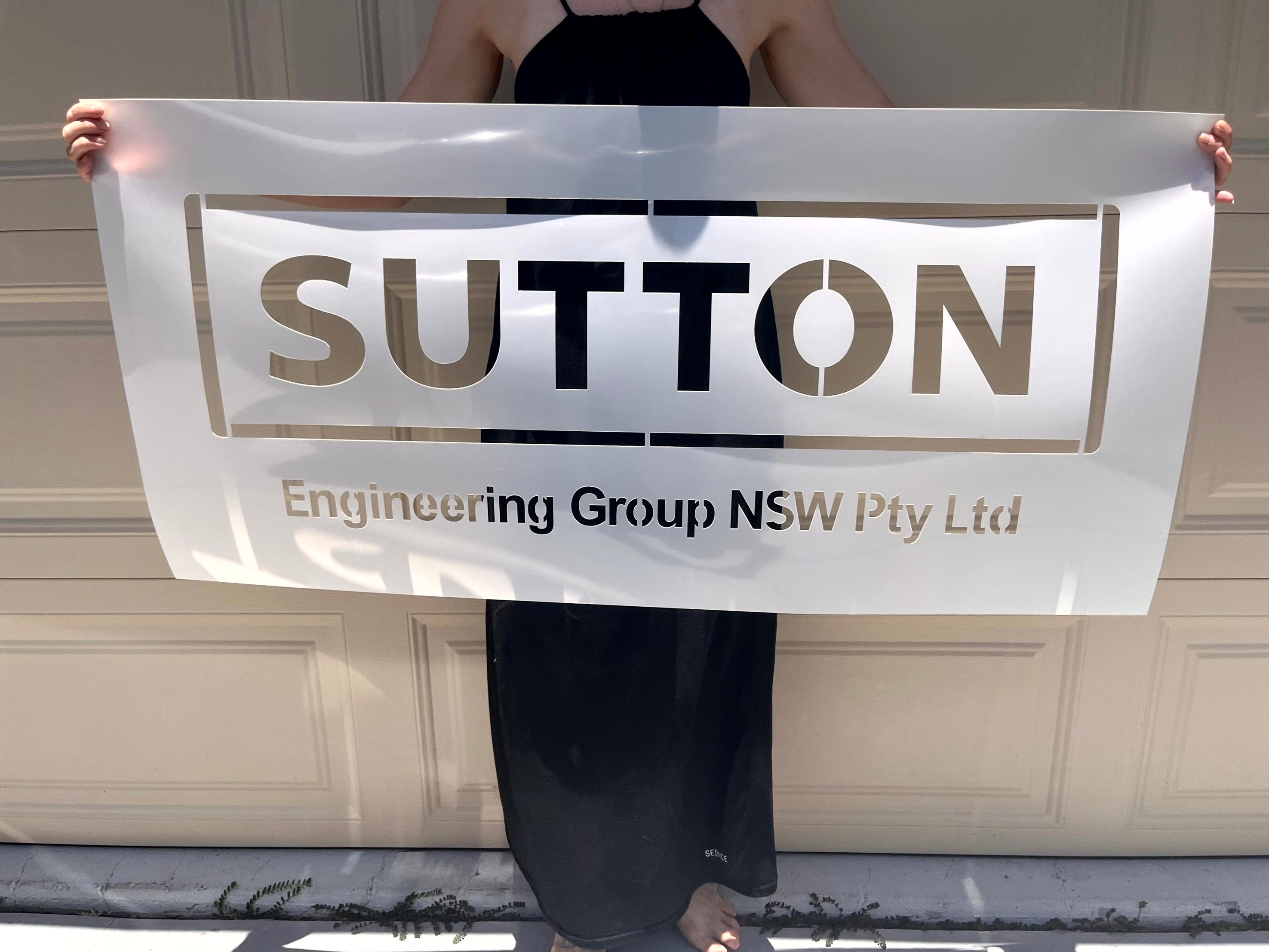 Custom industrial business stencil featuring the Sutton Engineering Group NSW Pty Ltd logo for professional branding applications.