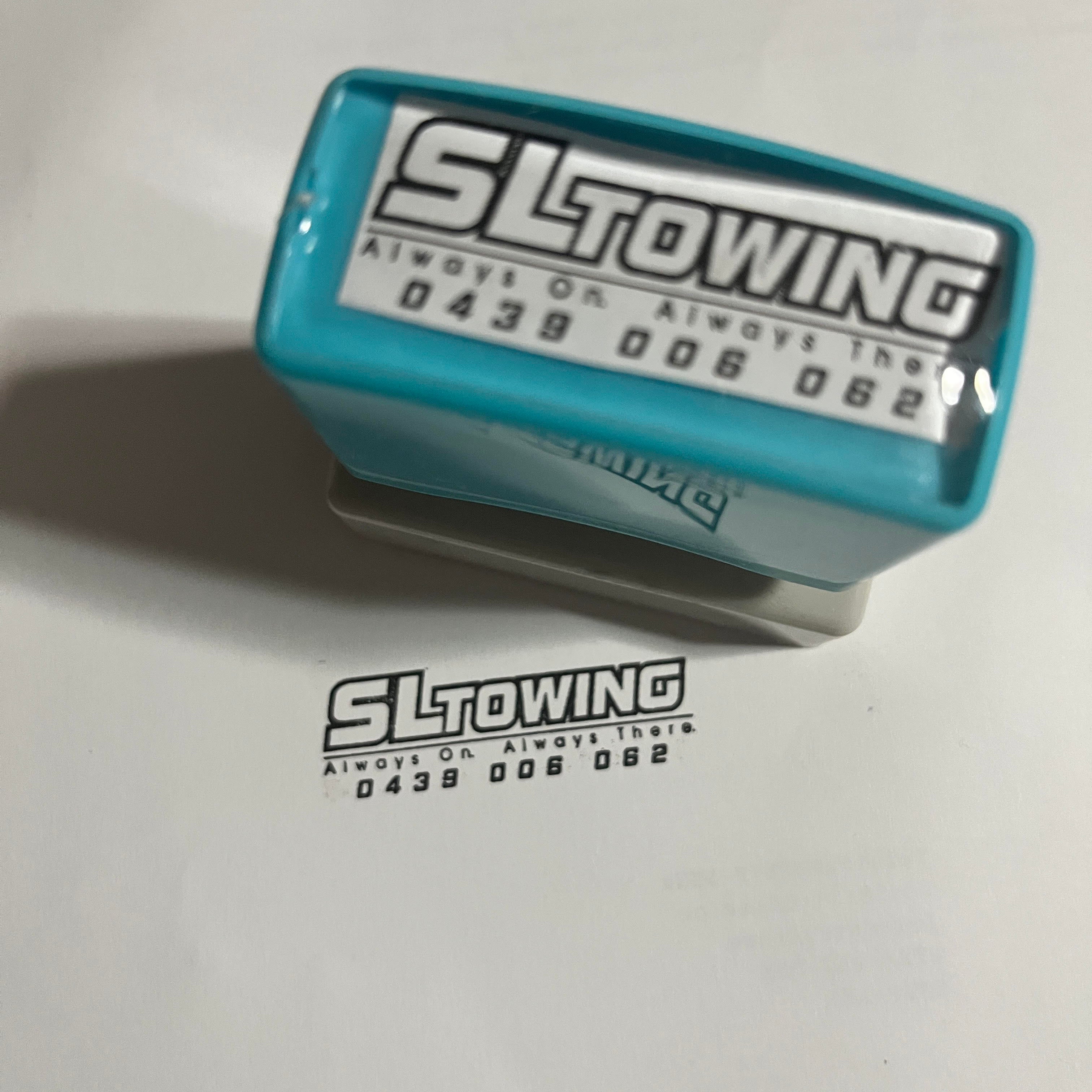 self-inking stamp beside paperwork.