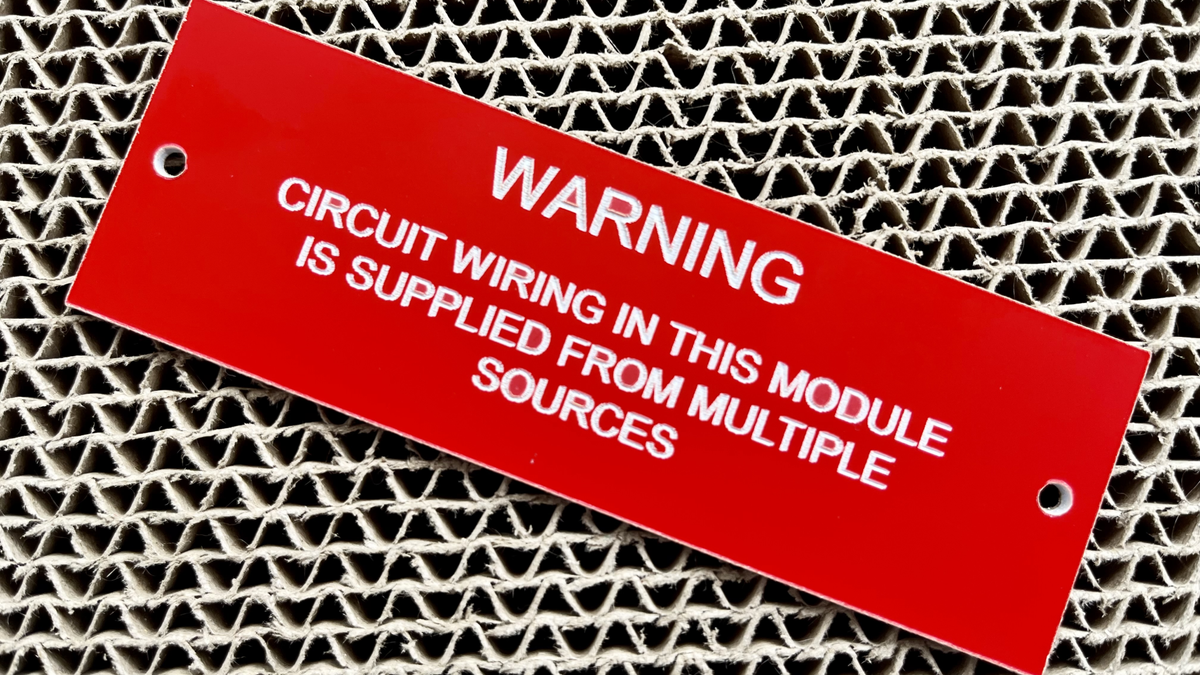 Red electrical warning sign with white text